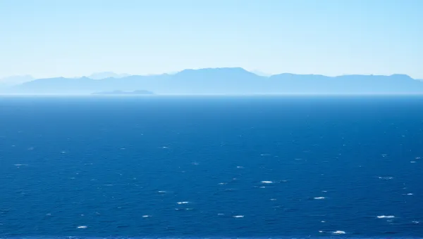 Expansive Deep Blue Sea Near Mountain Range