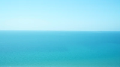 Expansive Deep Sea Horizon Under Clear Sky
