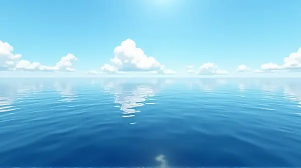 Wide view of deep indigo liquid reflecting scattered clouds under a bright sky from a low angle