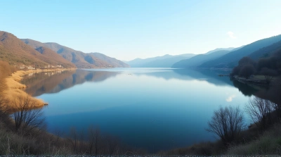 Expansive Lake Surface With Reflections And Hills