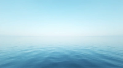 Expansive Still Water Under Clear Blue Sky