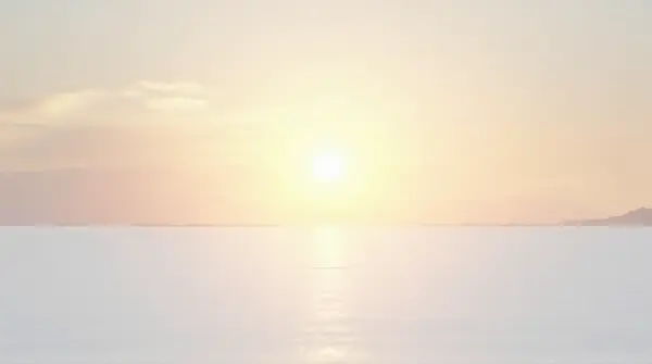 Wide white ground with soft light casting long shadows under a warm pastel sky from a low angle.