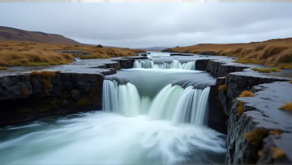 Flowing Stream Over Rocky Ledges Under Cloudy Sky