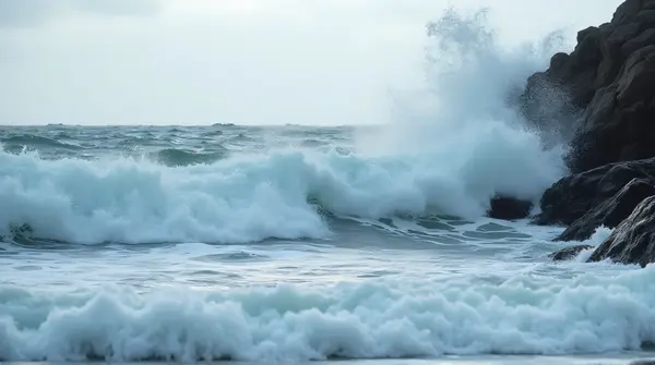 Foamy Ocean Swells Crashing Jagged Rocks
