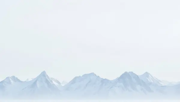 Frosted Mountain Peaks Under Pale Sky Horizon