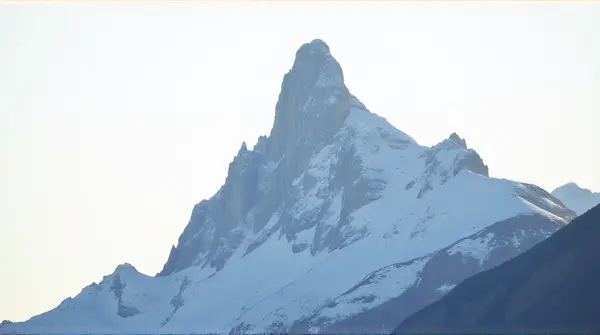 Frosted Summit With Rocky Slopes And Crisp Air