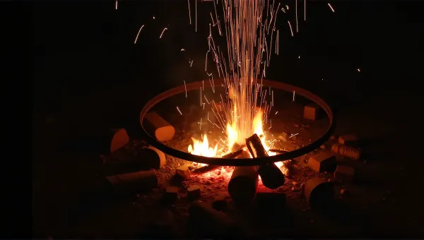 Glowing Campfire Flames In Metal Fire Ring