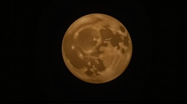 A glowing moon orb displaying detailed craters and surface features against a dark sky.