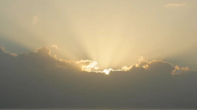 Golden Sunlight Breaking Through Layered Gray Clouds