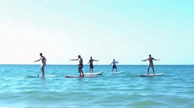 Group Paddleboarding On Saltwater Under Clear Sky