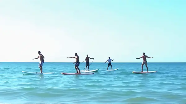 Group Paddleboarding On Saltwater Under Clear Sky