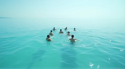 Group Swimming Across Clear Calm Water From Above
