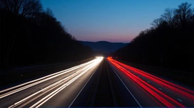 Highway Traffic Streaks At Twilight With Trees