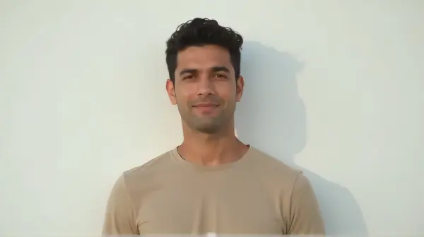 Individual Standing Upright Against Plain Background
