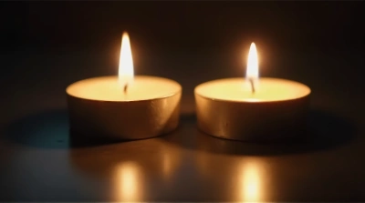 Ivory Tea Light Candles Flickering Together Close-Up