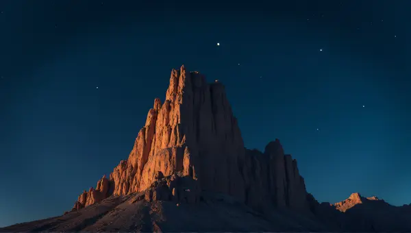 Jagged Brown Peak Against Deep Blue Sky