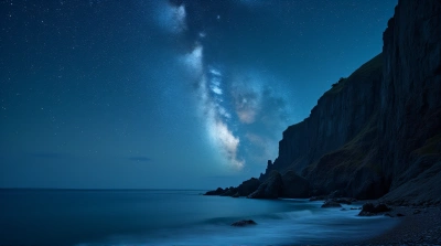 Jagged Cliffs Beside Calm Ocean Under Starry Sky