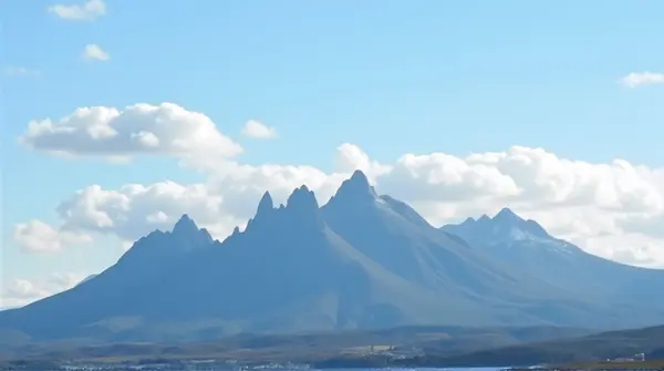 Jagged Mountain Range With Bright Sky Horizon