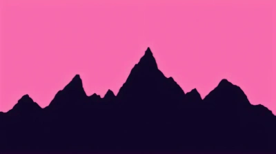Jagged Mountain Range Silhouette Against Pink Sky