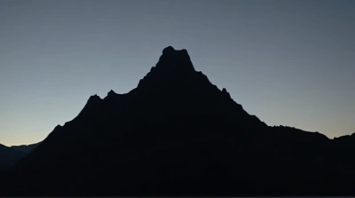Jagged Peak Silhouette Against Fading Sky