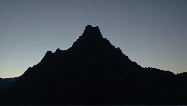 Jagged Peak Silhouette Against Fading Sky