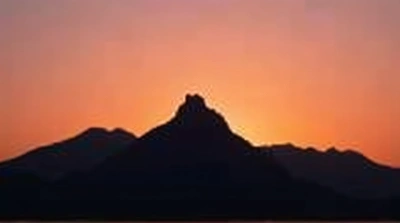 Jagged Peak Silhouette With Warm Horizon Glow