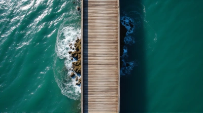 Long Jetty Extending Over Gentle Ocean Waves