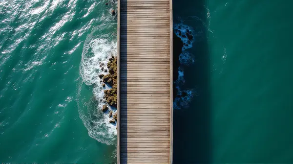 Long Jetty Extending Over Gentle Ocean Waves