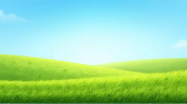 Low angle view of a meadow covered in vibrant green grass beneath a clear blue sky