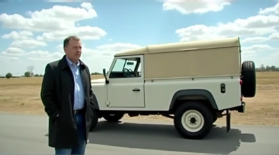 Man Standing Beside Utility Vehicle On Road