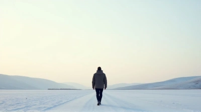 Man Walking Across Frosty Open Landscape