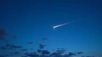 Meteor Streak Across Blue Dusk Sky