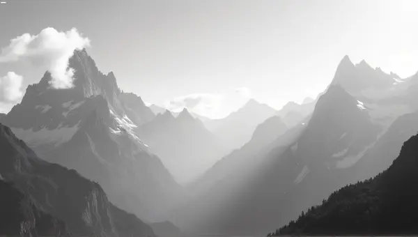 Monochrome Peaks With Sharp Ridges Under Bright Sky