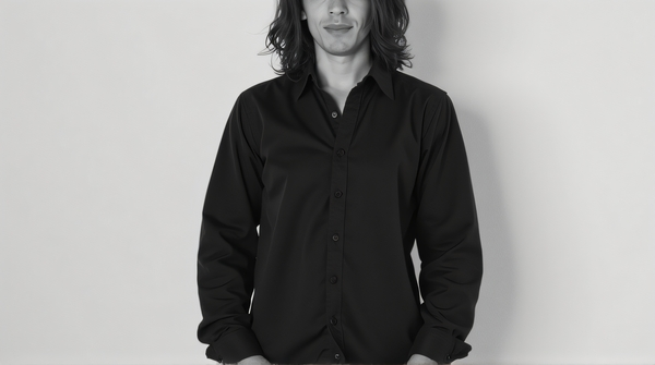 Black and white portrait showing detailed textures in clothing and hair against a plain background