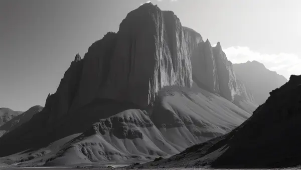 Monochrome Towering Cliff With Textured Steep Slopes