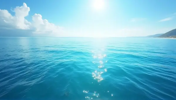 Ocean Surface With Sunlit Waves And Shoreline
