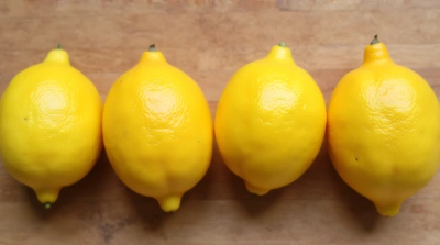 Oval Citrus Fruits On Wooden Surface With Shadows