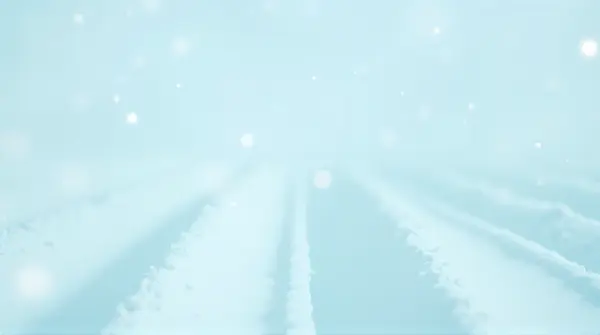 Low angle view of pale cerulean sky and snowy expanse segmented by delicate wisps