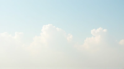 Pale Vapor Formations Against Gradient Sky