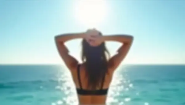 Person in Black Bra Facing Sunlit Ocean Horizon