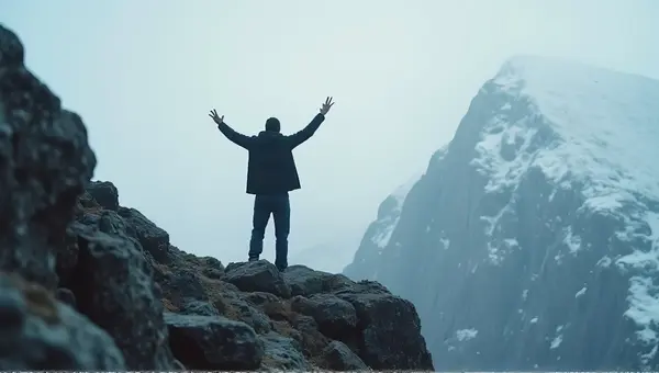 Person Celebrating On Frosty Rocky Summit