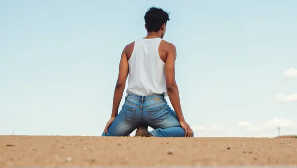 Person In Denim Pants On Granular Surface