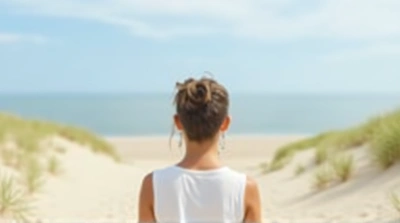 Person Gazing Over Coastal Dunes And Ocean Horizon