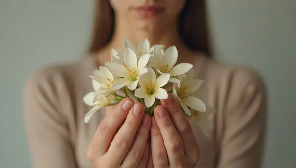 Person Holding Pale Blossoms Close Up