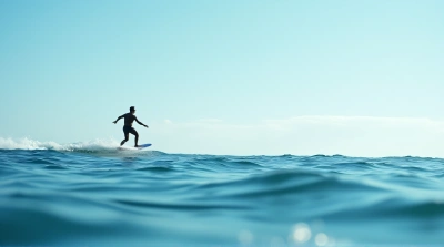 Person Paddleboarding On Calm Blue Water Horizon