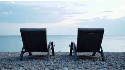 Reclined Lawn Chairs Overlooking Calm Coastal Water