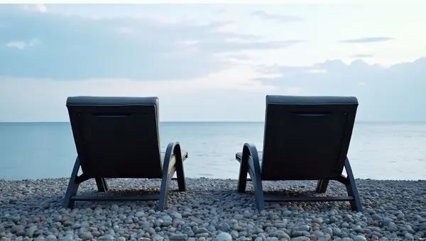 Reclined Lawn Chairs Overlooking Calm Coastal Water