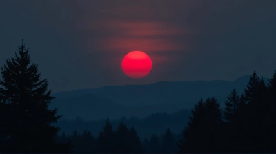 Red Sun Rising Over Rugged Horizon At Dusk