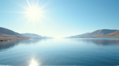 Reflective Water Surface Near Rolling Hills Under Sunlight