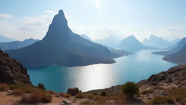 Rocky Peak Beside Shimmering Reservoir Under Open Sky